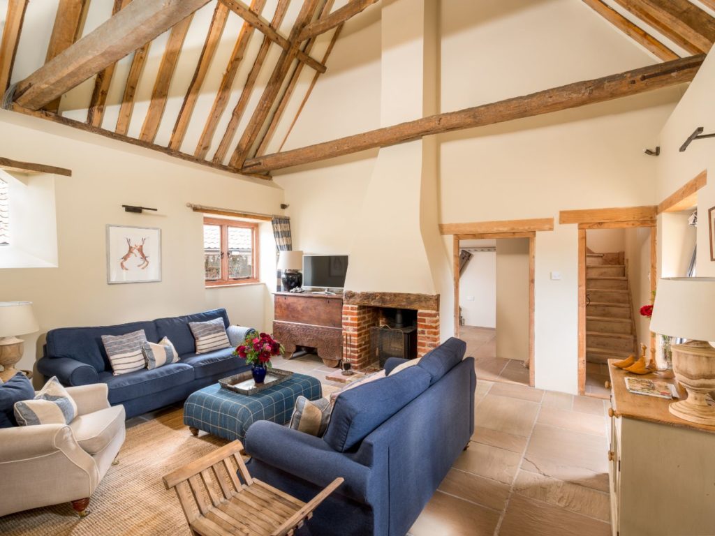 Manor Barn boasts a large and lovely beamed sitting room with a high ceiling;